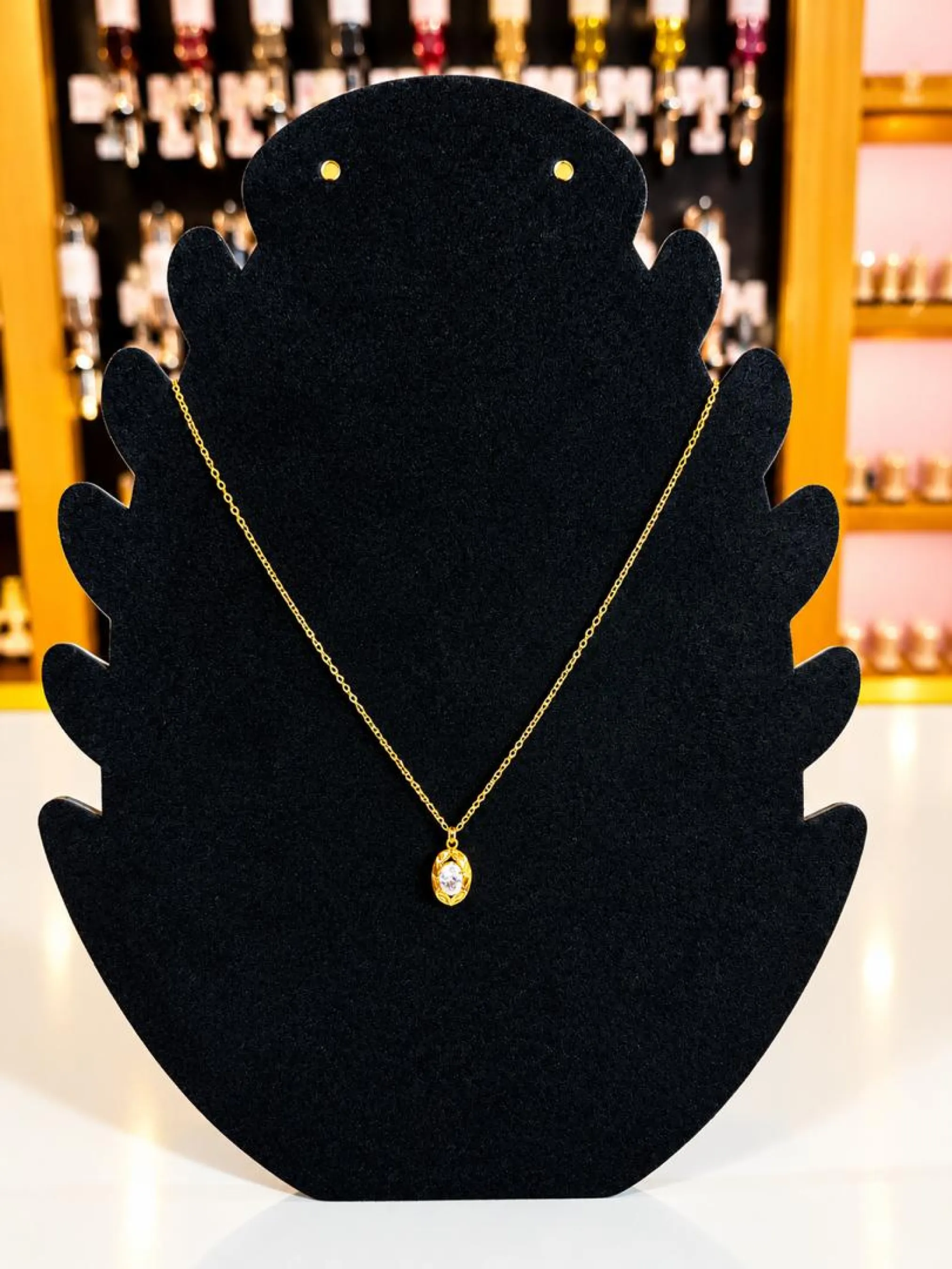 Collier doré à pendentif ovale serti